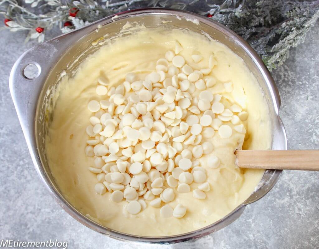 batter in a bowl with white chocolate chips on top