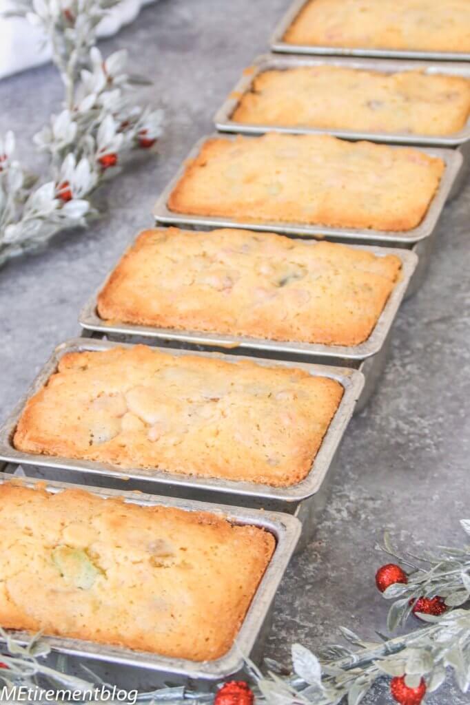 Cream Cheese Fruitcakes in their mini cake pans just out of the oven with garland on the left