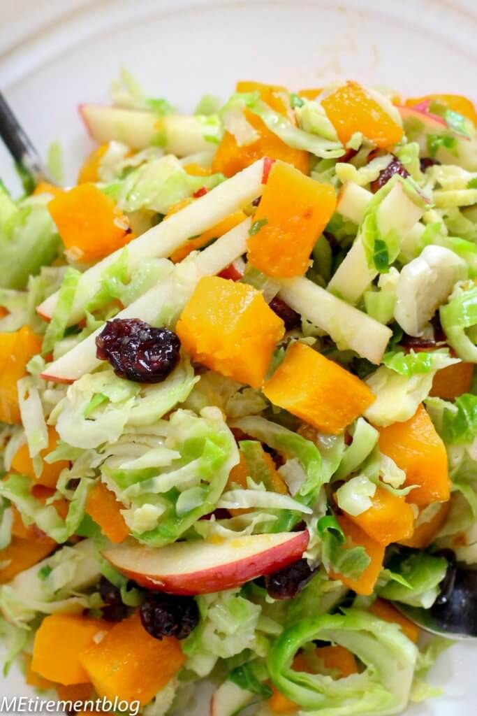 Close up of butternut squash, apples, and shaved Brussels sprouts in salad