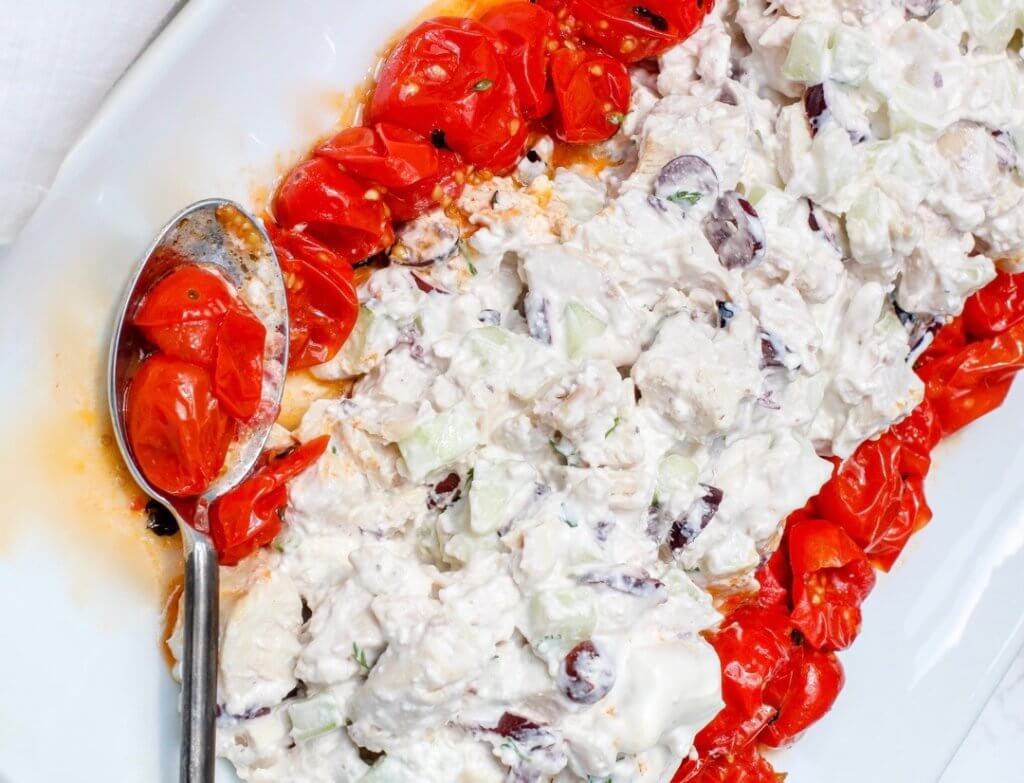 Close up of Greek Yogurt Chicken Salad with Feta and Blistered Tomatoes with a spoon