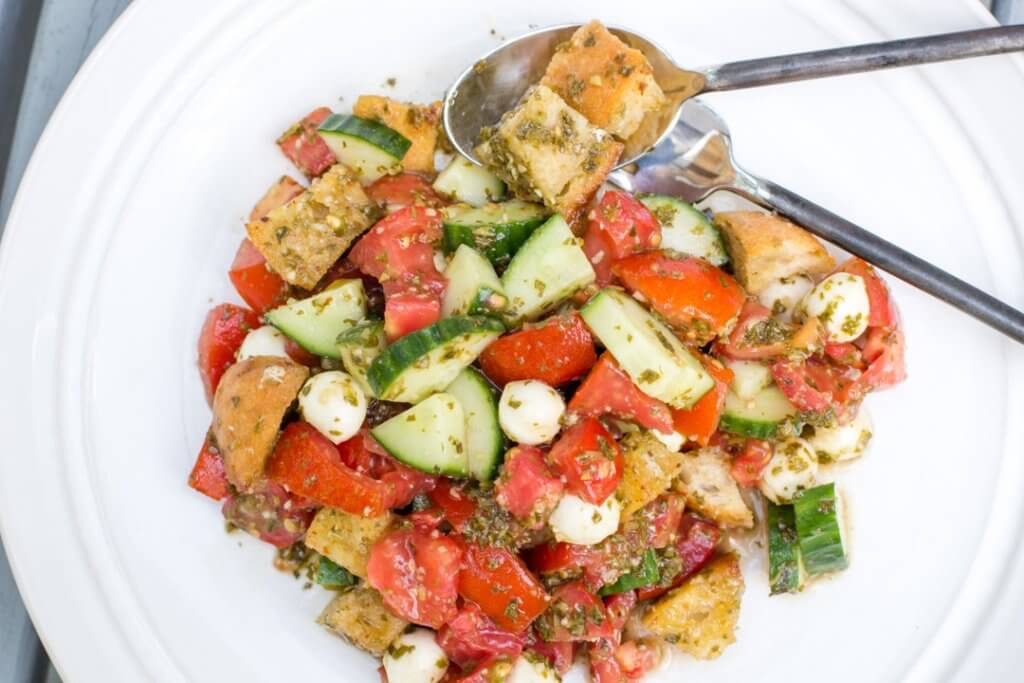 Panzanella Salad on white plate with serving utensils