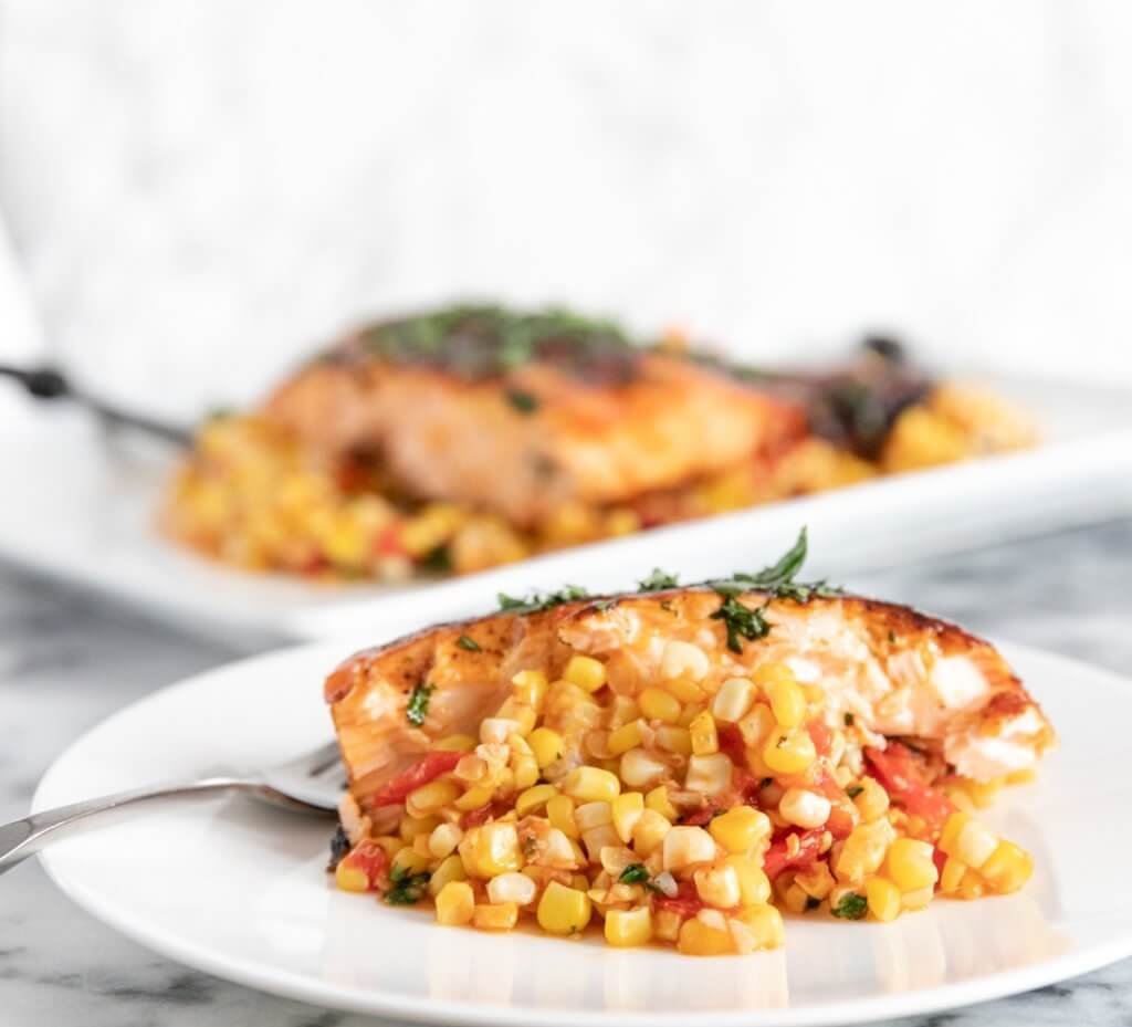 Close up of plated Grilled Glazed Salmon with Tomato Corn Saute
