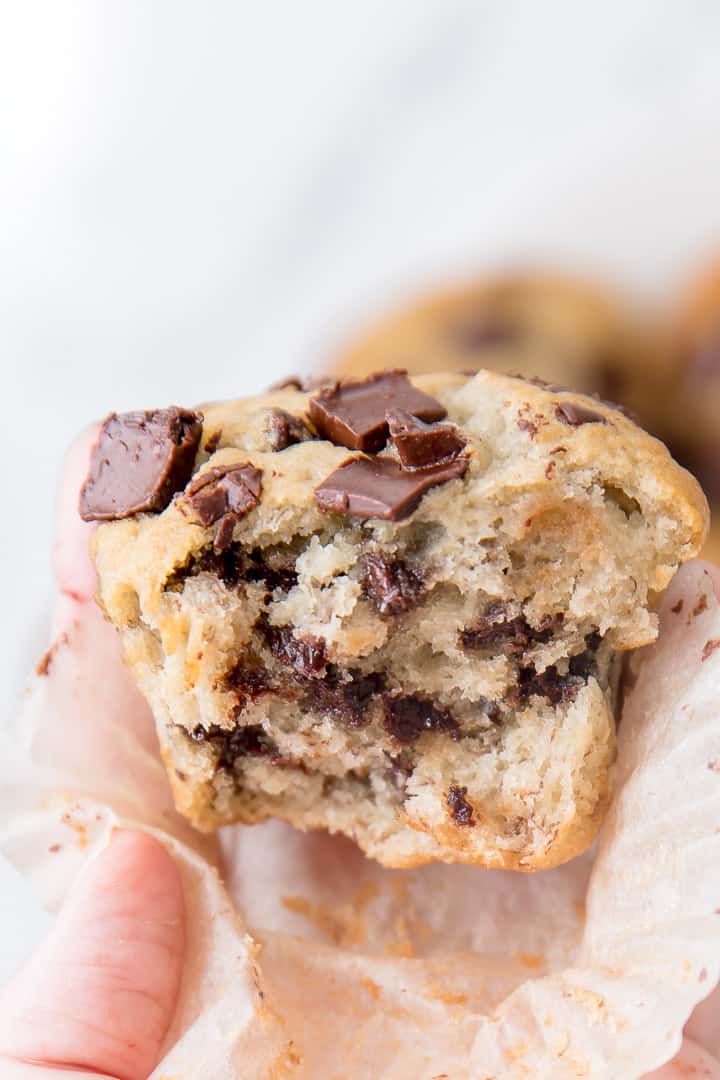 A chocolate chip muffin close up with a bite taken out